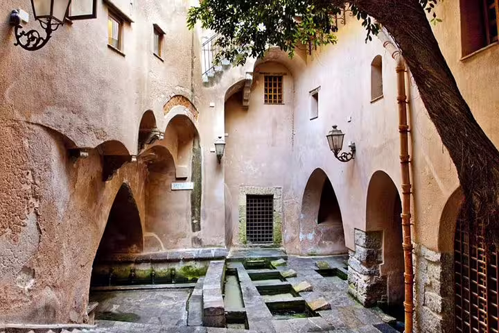 Medieval wash house and arches in historic Cefalù old town, included on the Monreale, Bagheria and Cefalù private day trip from Palermo