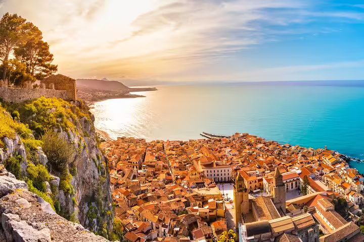Sunset panorama over Cefalu rooftops and Tyrrhenian Sea, scenic stop on private Sicilian day trip from Palermo