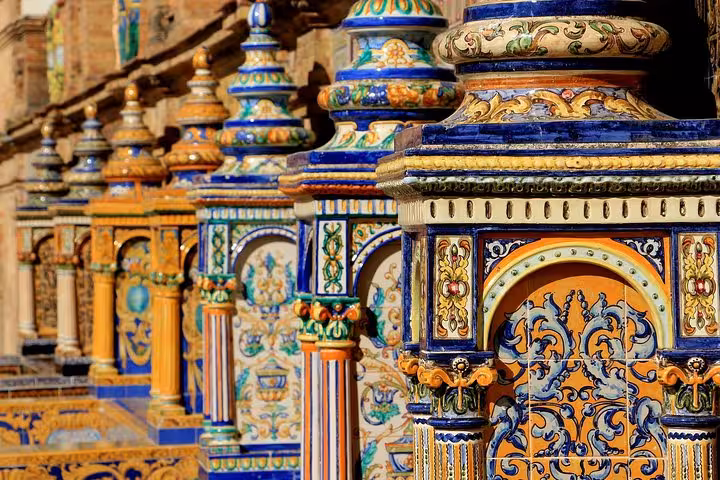 Colorful ceramic tiles in Plaza de España, Seville, showcasing intricate Andalusian craftsmanship and vibrant designs.