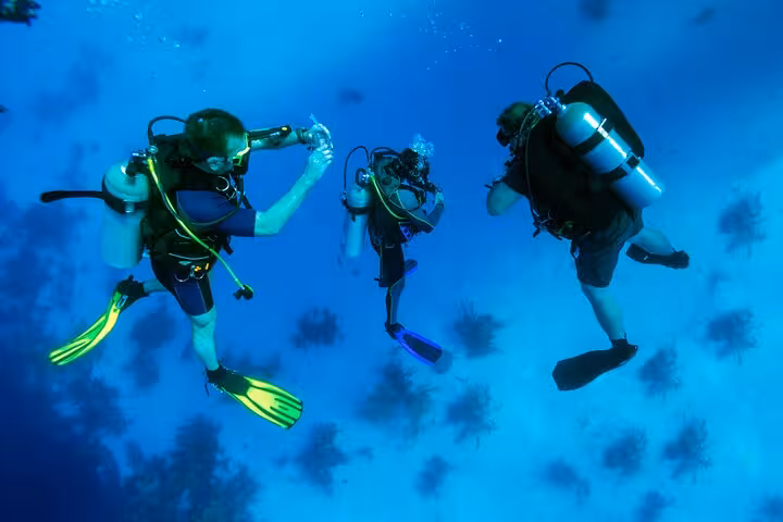 Certified divers practicing underwater skills on a guided Hurghada Red Sea scuba dive with instructor support