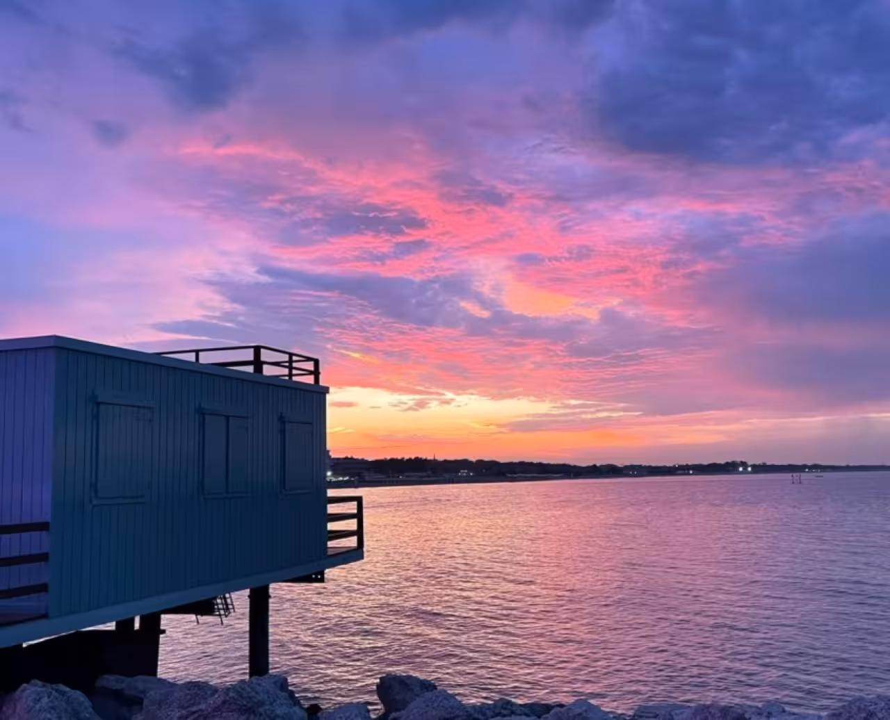 Sunset over the Adriatic Sea in Cesenatico, pastel sky reflecting on water during panoramic coast tour