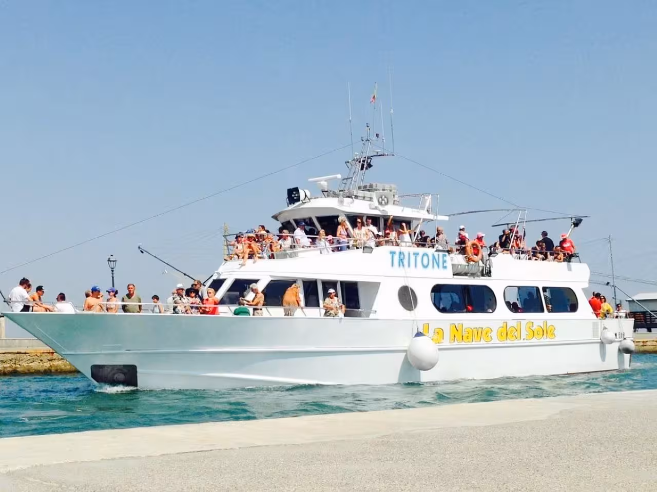 Crowded tour boat departing Cesenatico harbor for an afternoon cruise along the Riviera Romagnola, Adriatic Sea