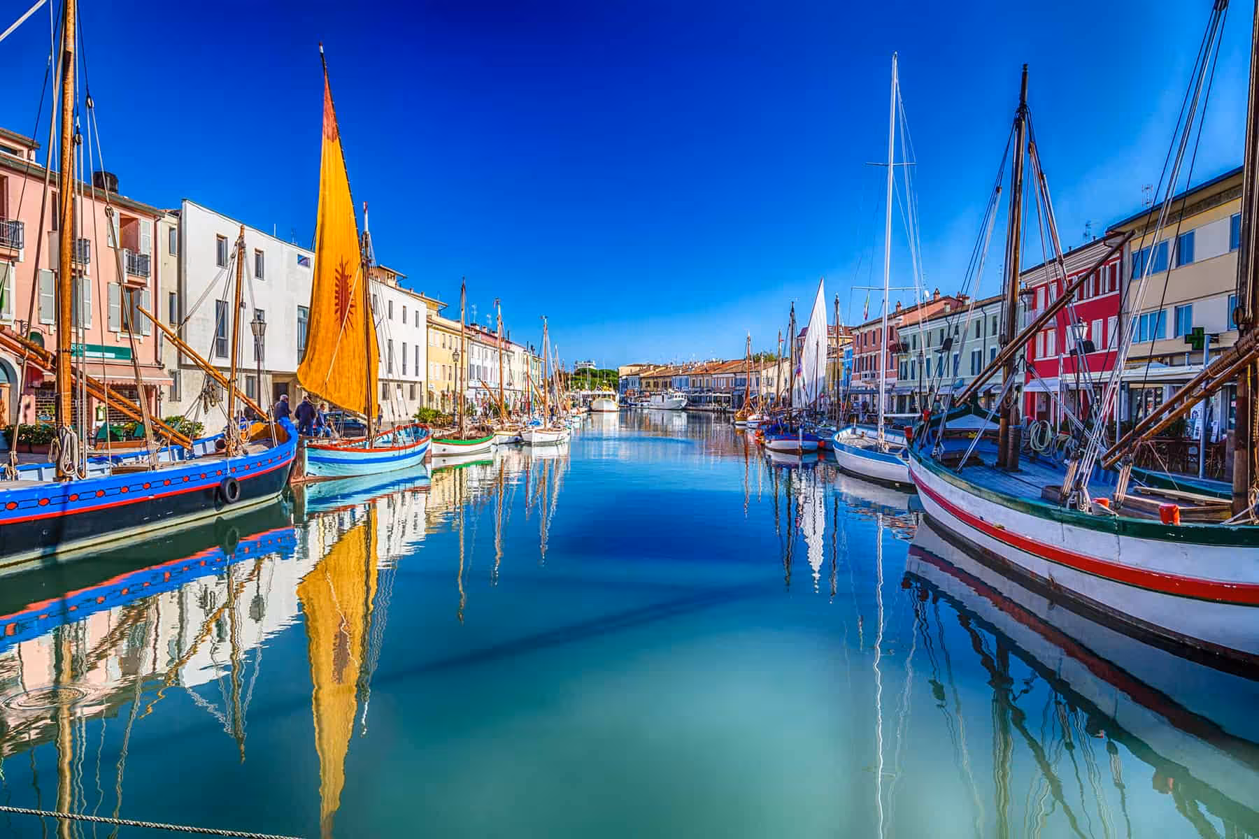 Cesenatico canal harbor with traditional sailboats, scenic view near Maritime Museum and Marino Moretti House