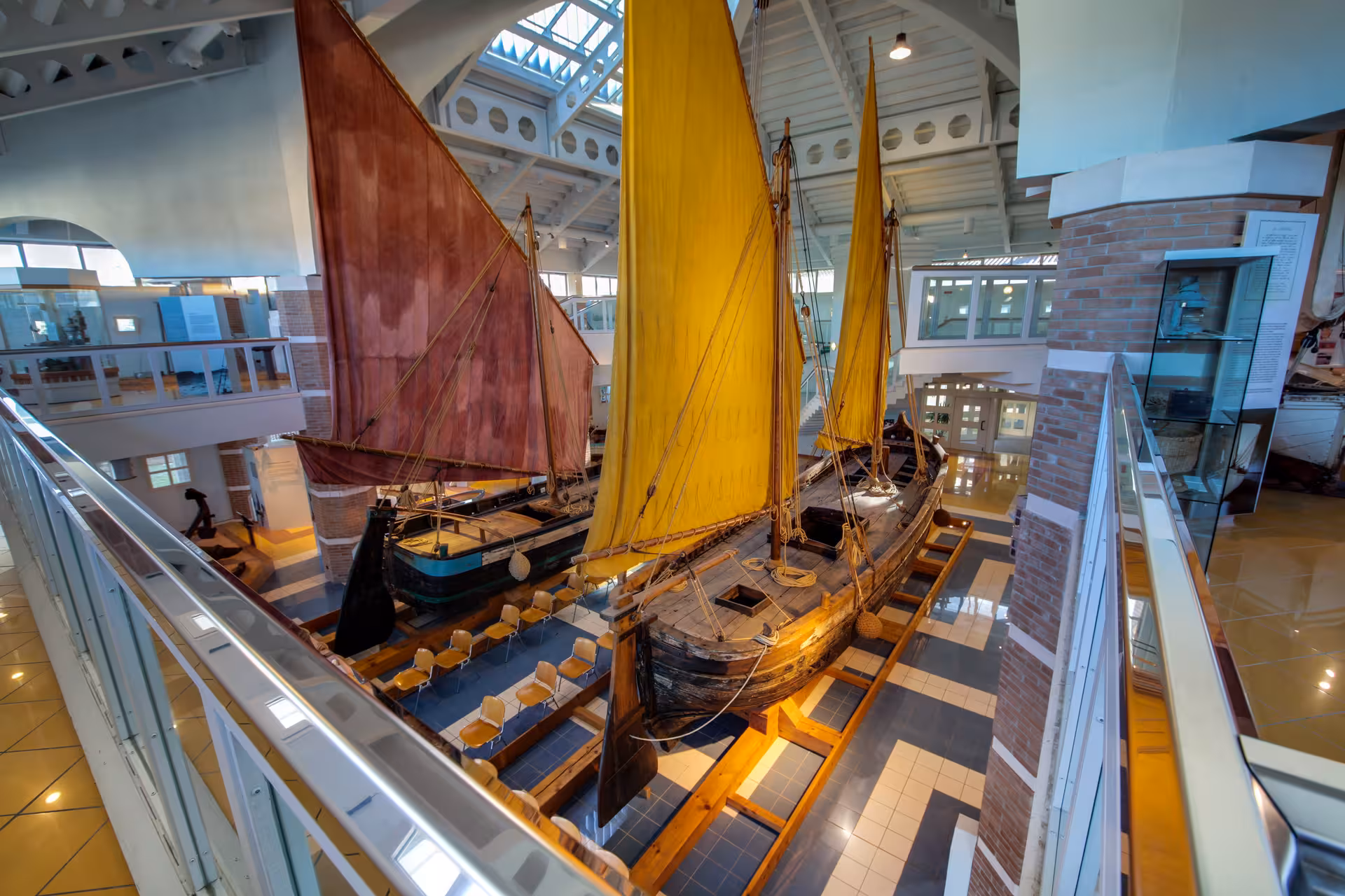 Traditional sailboats with yellow and red sails inside Cesenatico Maritime Museum, Emilia-Romagna Italy