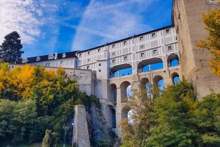 Cesky Krumlov Castle bridge and arches above the river, scenic highlight on Prague to Vienna private transfer tour
