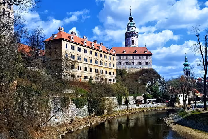 Cesky Krumlov Castle above the Vltava River under blue skies on a small-group day trip from Vienna