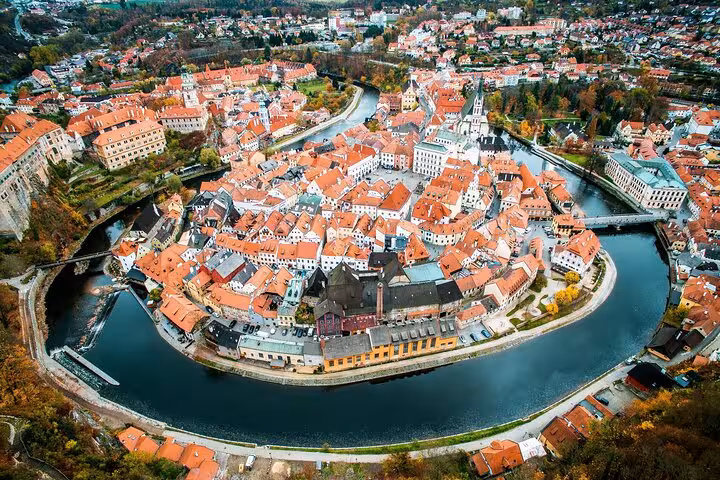 Aerial view of Cesky Krumlov old town and Vltava river bend, popular stop on Prague to Vienna private transfer
