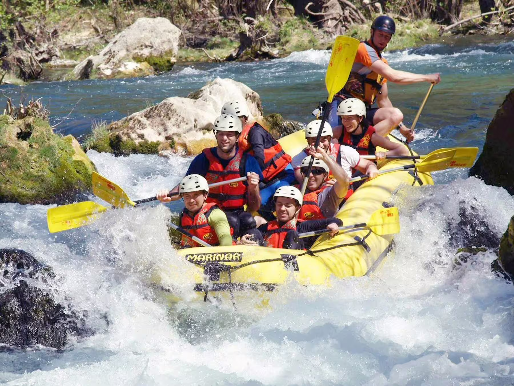 Adventure rafting on the Cetina River from Makarska Riviera with transfer, team splashing through whitewater