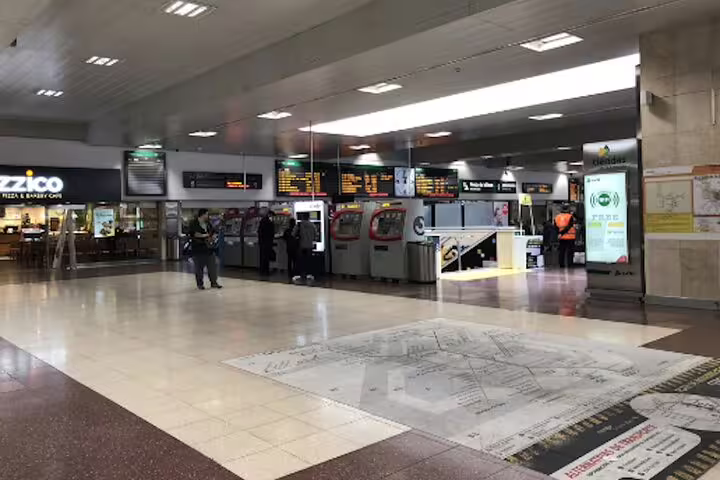 Chamartin Station Madrid concourse with ticket machines and departures board, private hotel pickup transfer