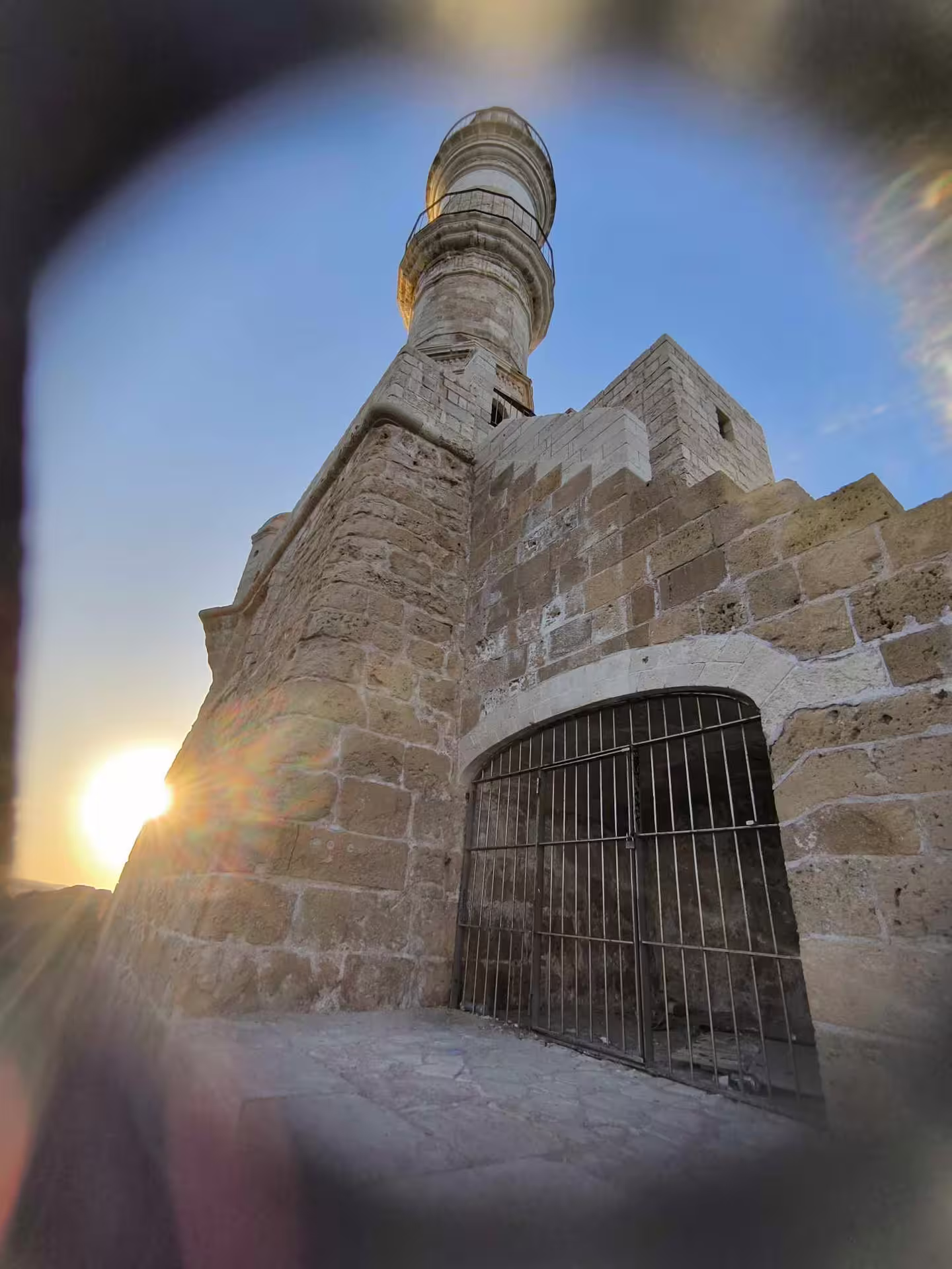Sunset view of the historic lighthouse in Chania, capturing its architectural grandeur on the semi-private tour.