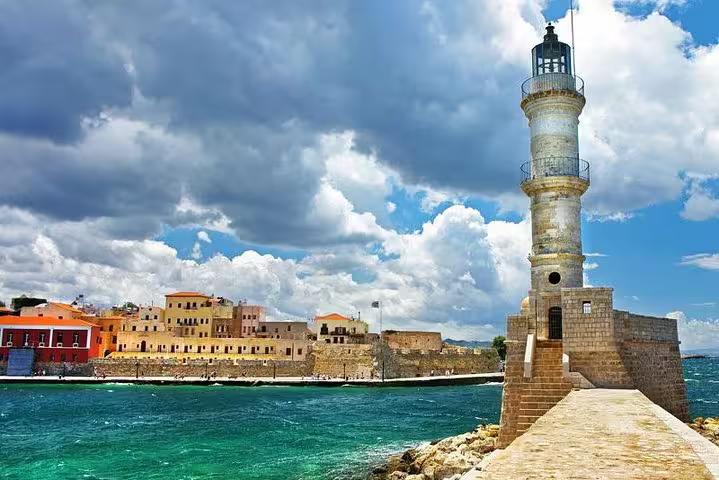 Chania lighthouse on the Venetian Harbor breakwater with turquoise sea, scenic photo stop from Rethymno excursion