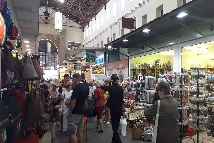 Bustling Chania market scene with tourists exploring vibrant shops, ideal for West Crete private tour of Chania, Rethymno, Kournas Lake.