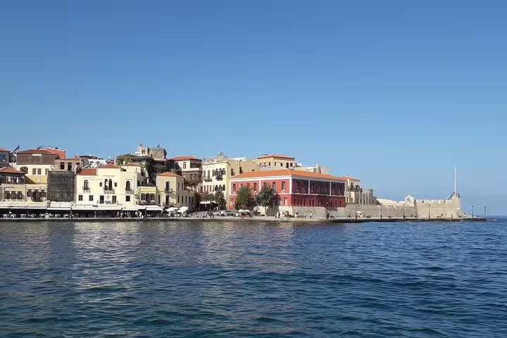 Scenic view of Chania Old Town harbor with colorful historic buildings along the waterfront.