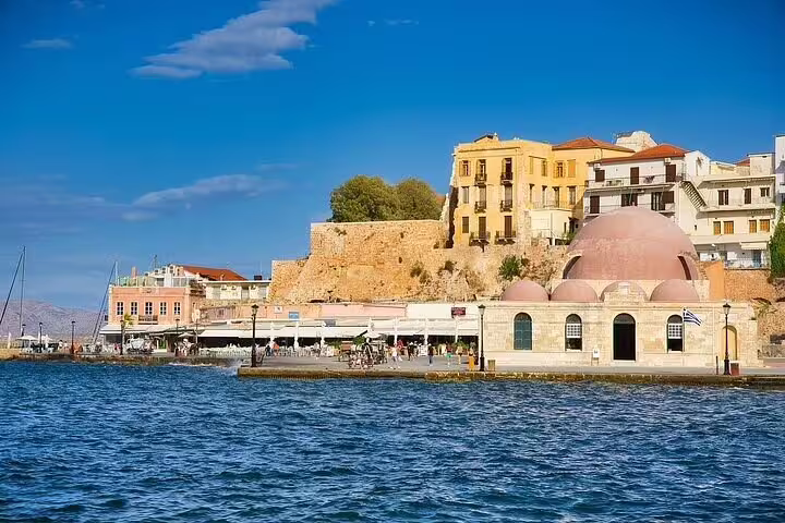 The picturesque waterfront of Chania Old Town, showcasing historic buildings and vibrant seaside views under a clear blue sky.