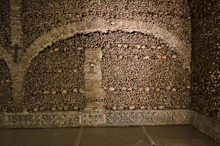 Visit the haunting Chapel of Bones in Évora, adorned with human skulls, on a captivating full day tour from Lisbon.