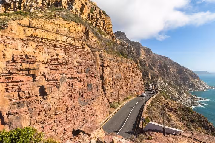 Scenic coastal drive along dramatic cliffs at Chapman's Peak, a highlight of the Cape Point tour from Cape Town.