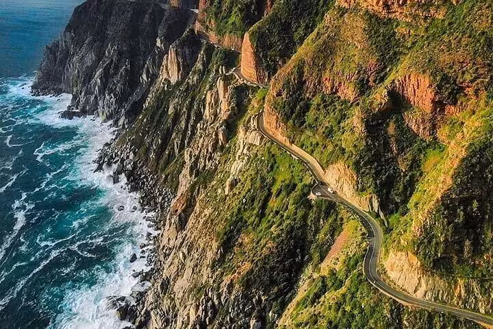 Aerial view of Chapman's Peak Drive, showcasing the stunning coastal cliffs and ocean vistas on the Cape Peninsula tour.