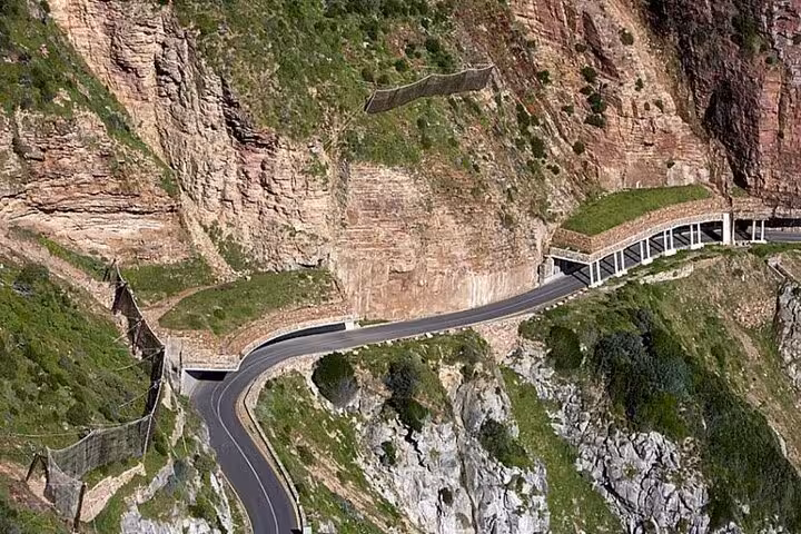 Scenic view of Chapman's Peak Drive, an iconic coastal road carved into the cliffs of Cape Town's rugged mountains.
