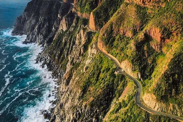Breathtaking aerial view of Chapman's Peak Drive with dramatic cliffs and ocean vistas on Table Mountain tour.