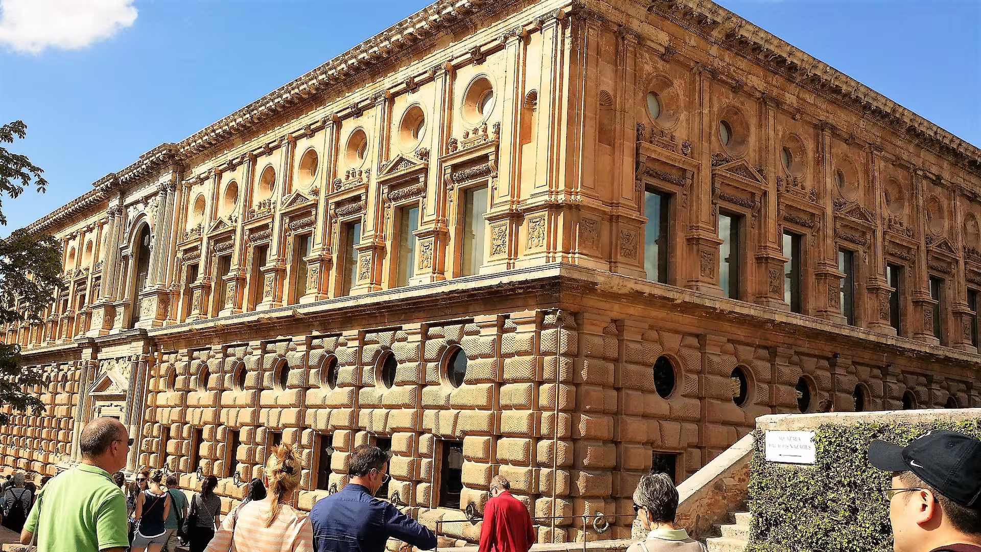 Exterior of Charles V Palace at the Alhambra, Granada, with visitors on a Costa del Sol group excursion