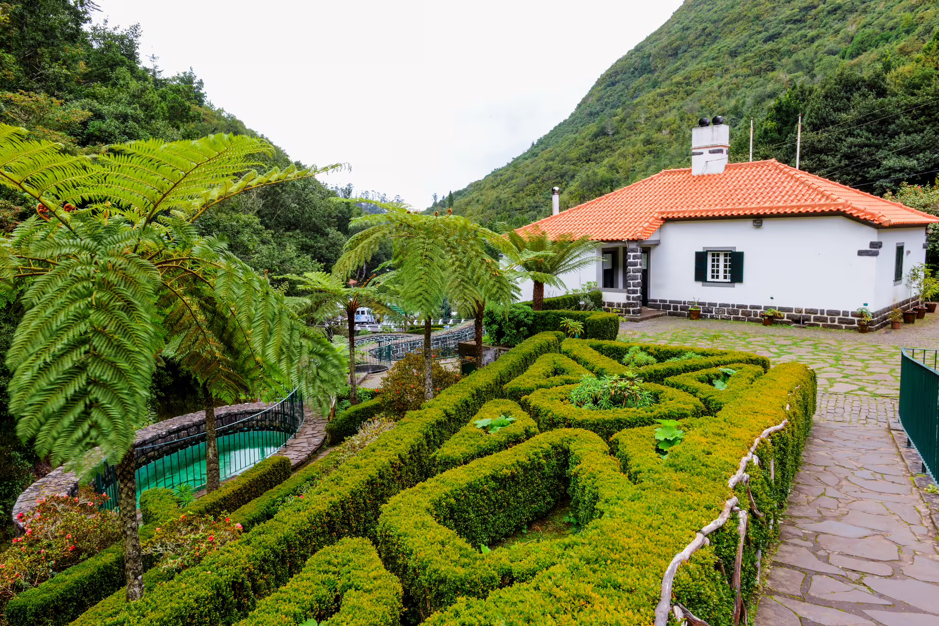 Charming house with manicured garden and mountain views on the Around the Island Tour.