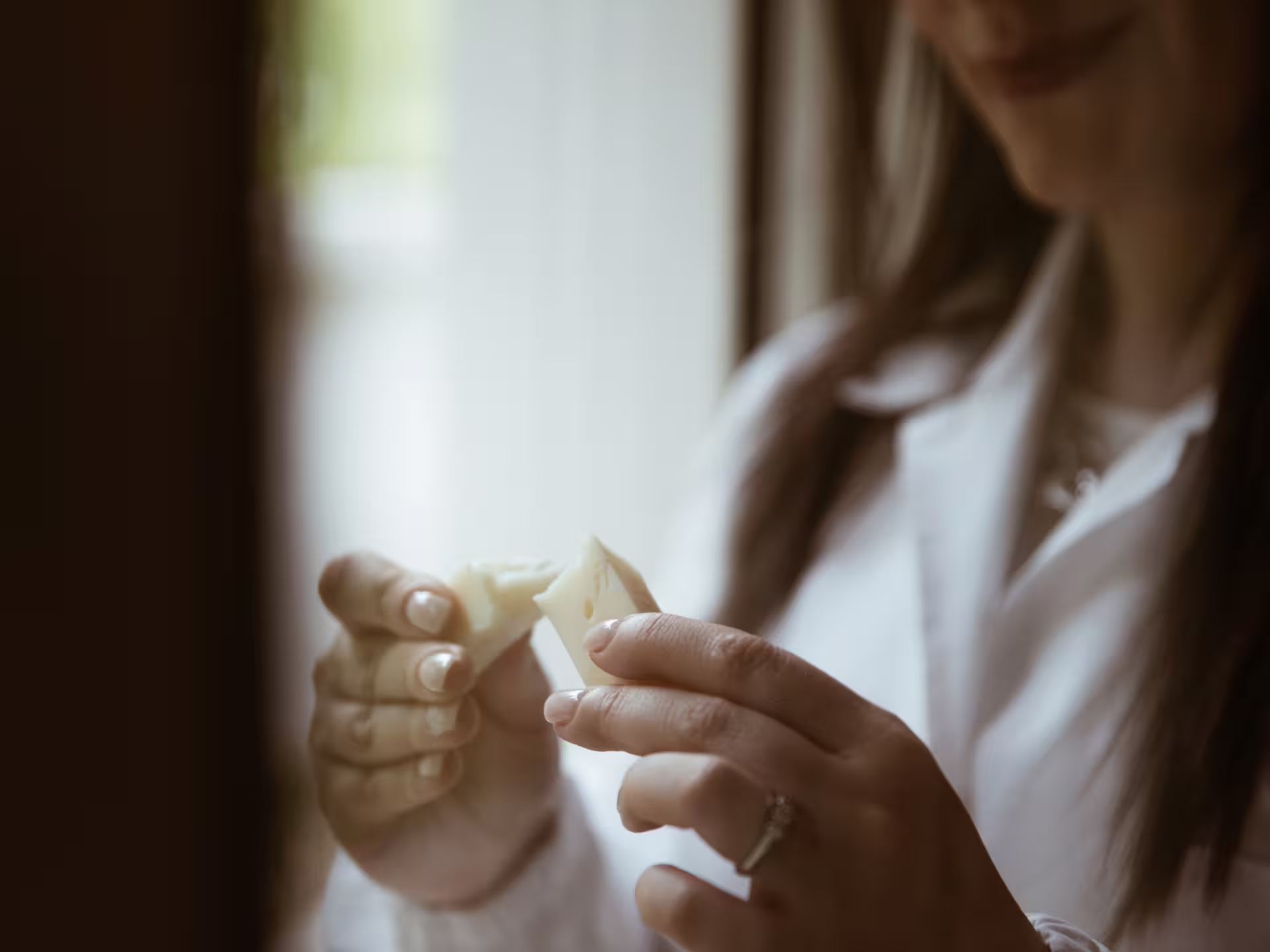 Woman enjoying a cheese tasting experience at a traditional factory in Isernia countryside.