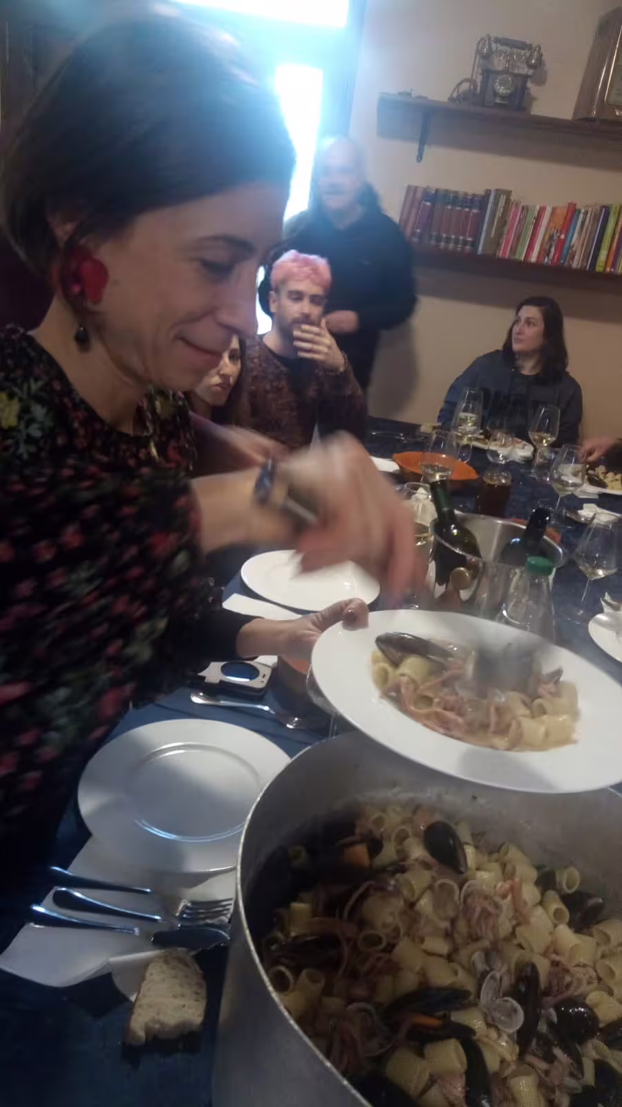 Home restaurant dinner with chef Angelo Lanaro, guests enjoying fresh seafood pasta and local wine pairing