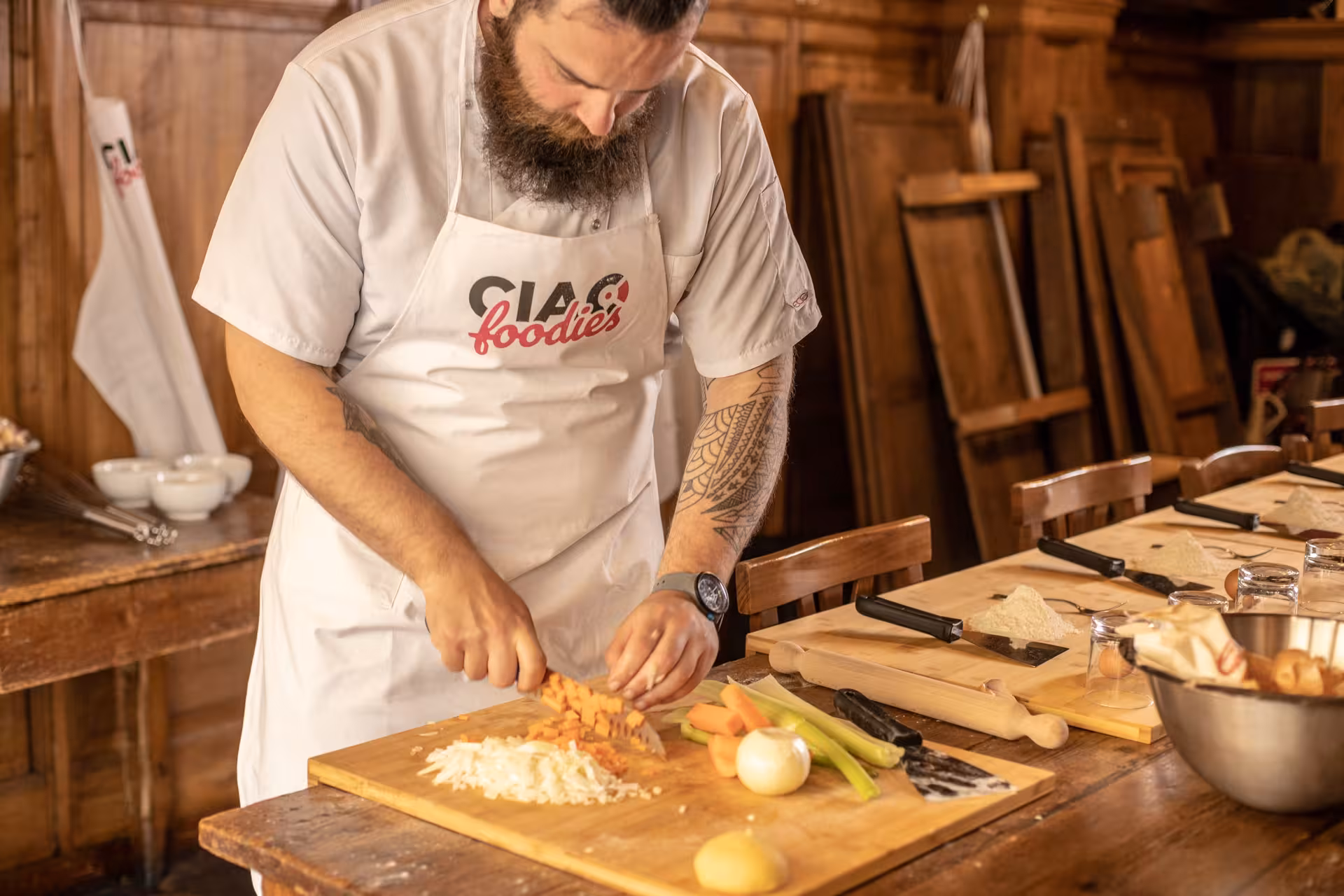 Chef chopping vegetables in a cozy kitchen for a hands-on cooking class in Florence.