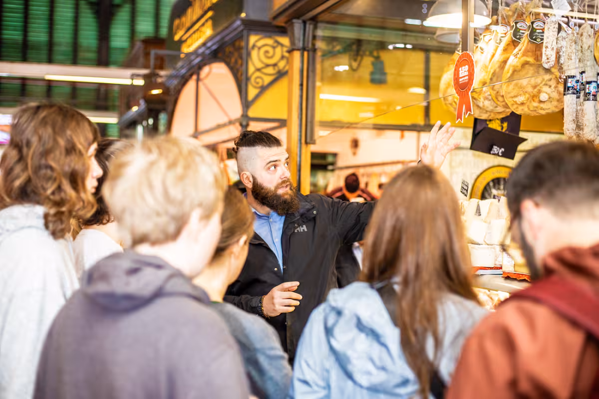 Chef explains Italian cheeses to an engaged group during the Sant’Ambrogio market food tour in Florence.