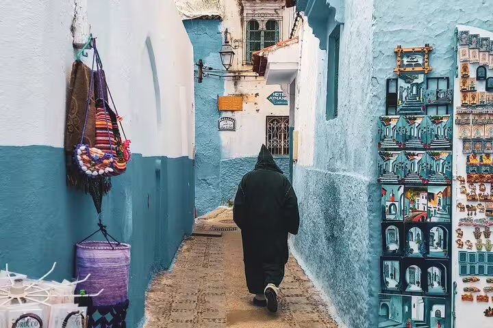 Chefchaouen blue alley with Moroccan souvenirs, a highlight on the 15-day Big Morocco Tour from Casablanca
