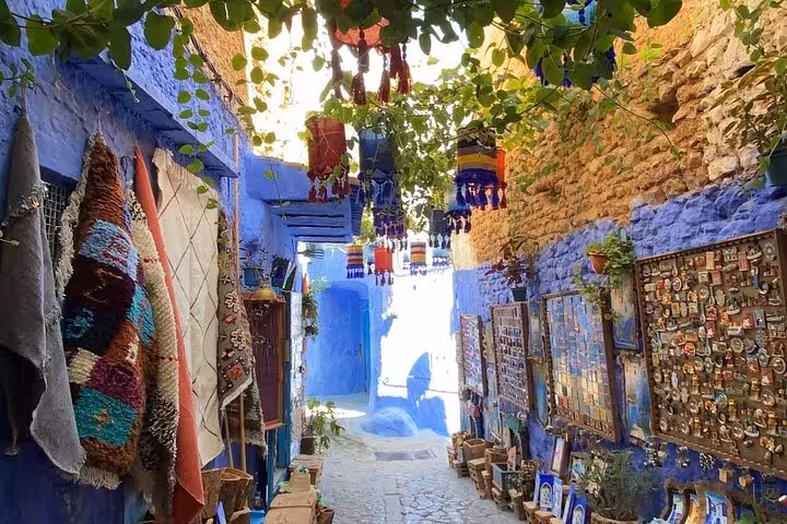 Wander through Chefchaouen's enchanting market street filled with colorful textiles and crafts on a tour from Fez.