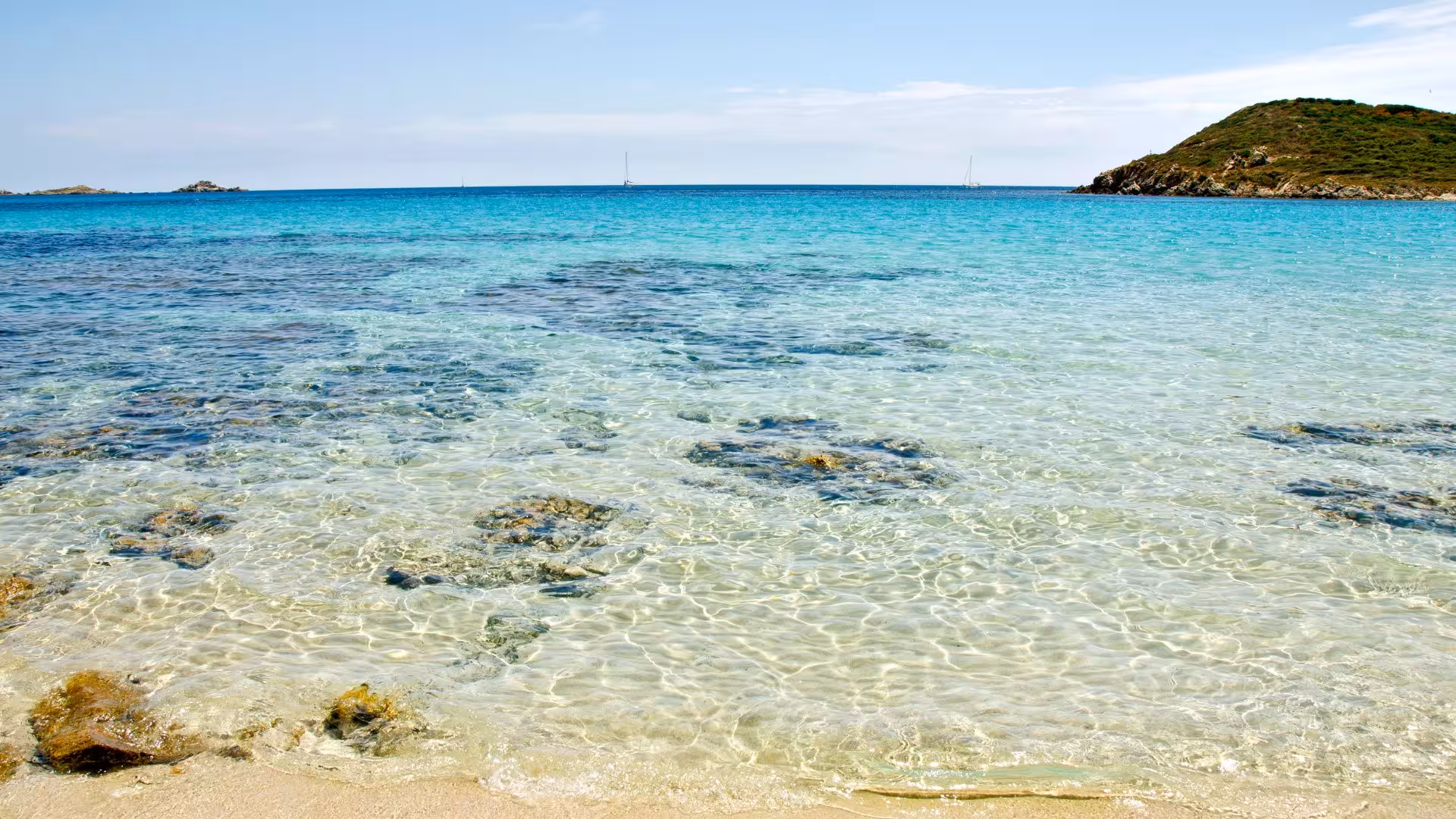 Pristine waters and sandy shorelines of Chia Beach, showcasing natural beauty for a Cagliari coastal tour.