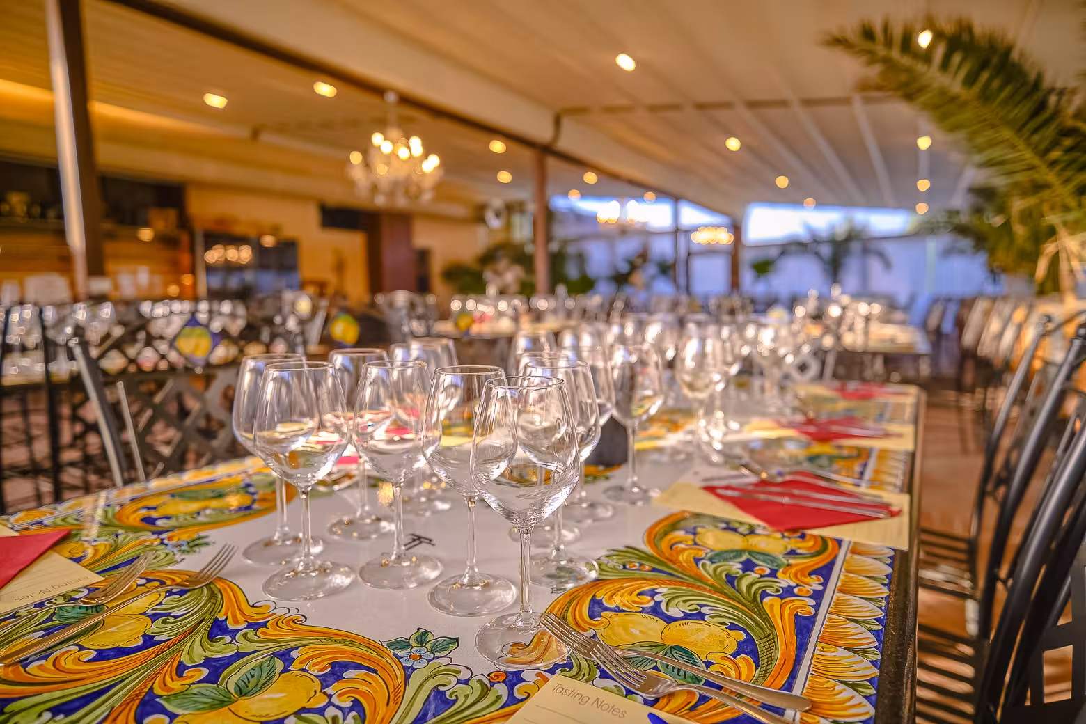 Elegant dining setup with wine glasses and vibrant tablecloths, ready for dinner on the Florence wine tour.