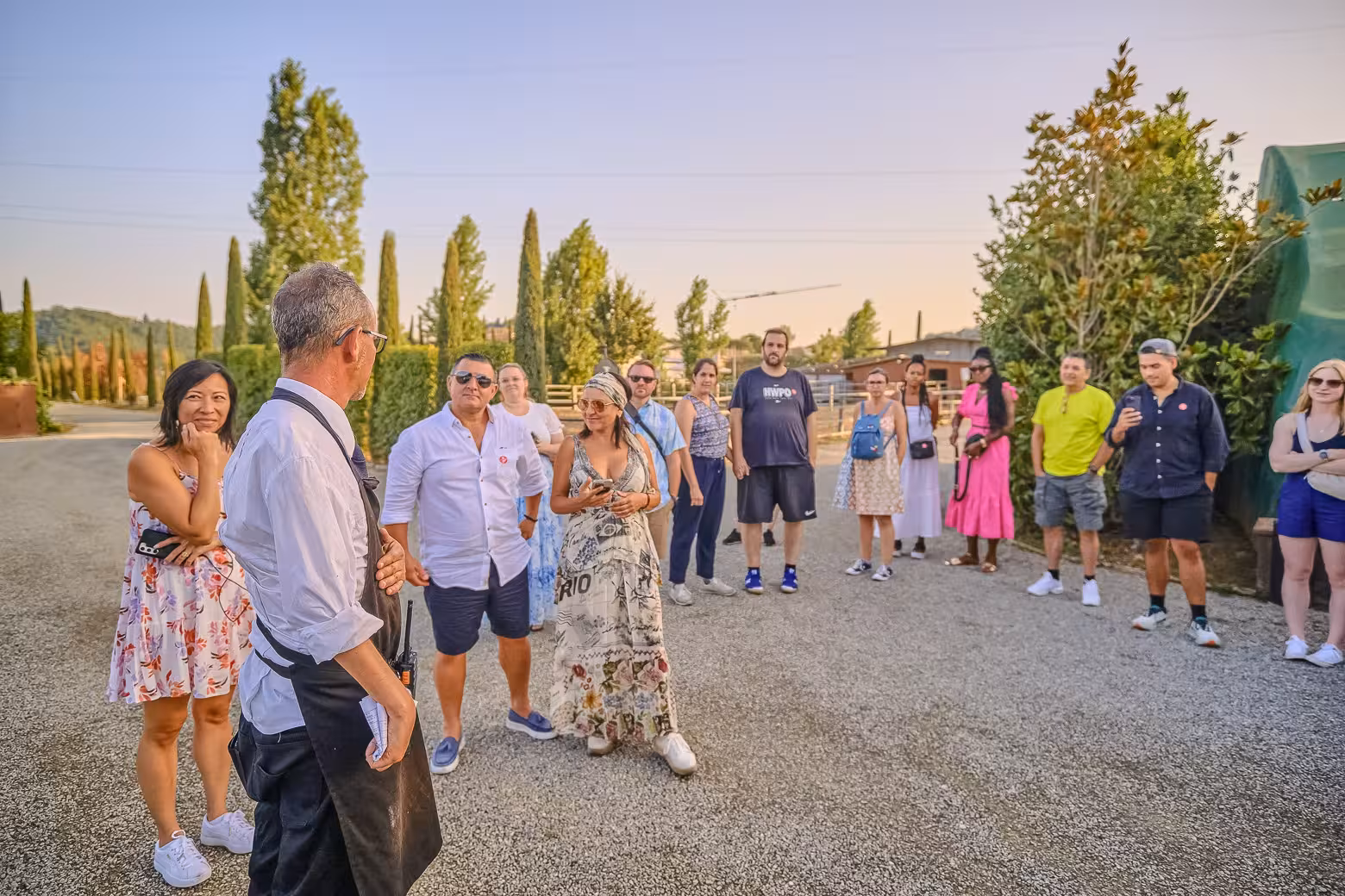 Tour group enjoying a sunny afternoon in Chianti during Siena wine tour from Florence.