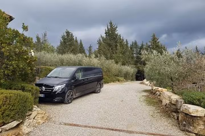 Private minivan pickup on a Chianti winery driveway for Castellina wine tasting day trip from Rome