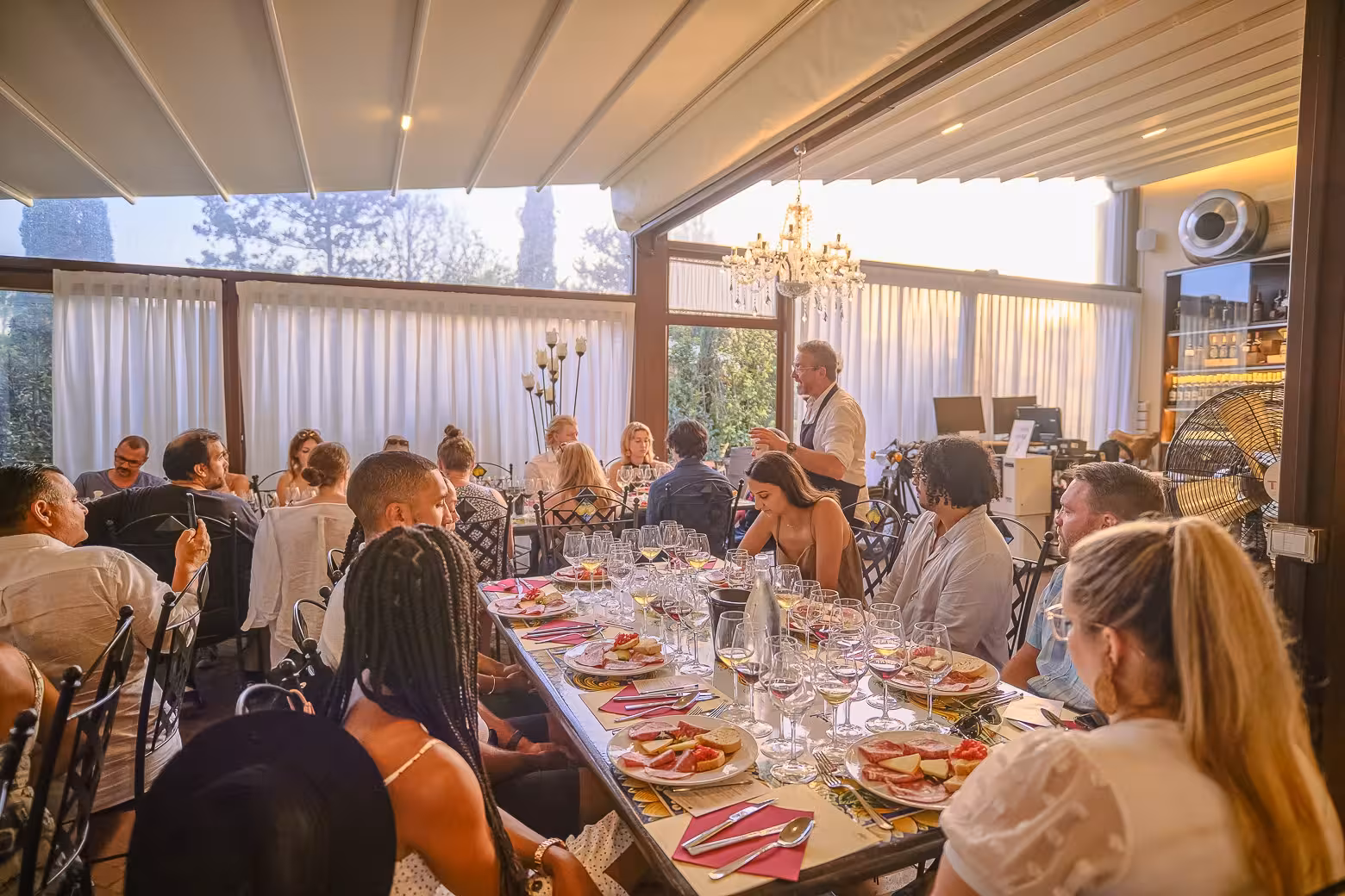 Guests listening to a presentation during a dinner on the Siena and Chianti wine tour from Florence.