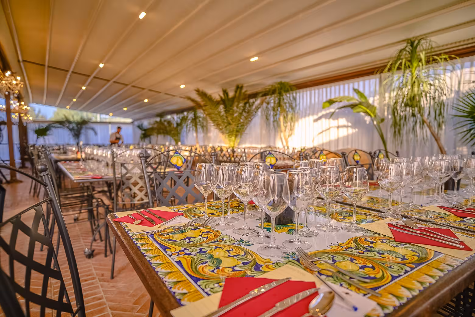 Elegant dining setup with wine glasses in Chianti winery, ready for a gourmet dinner under a stylish canopy.