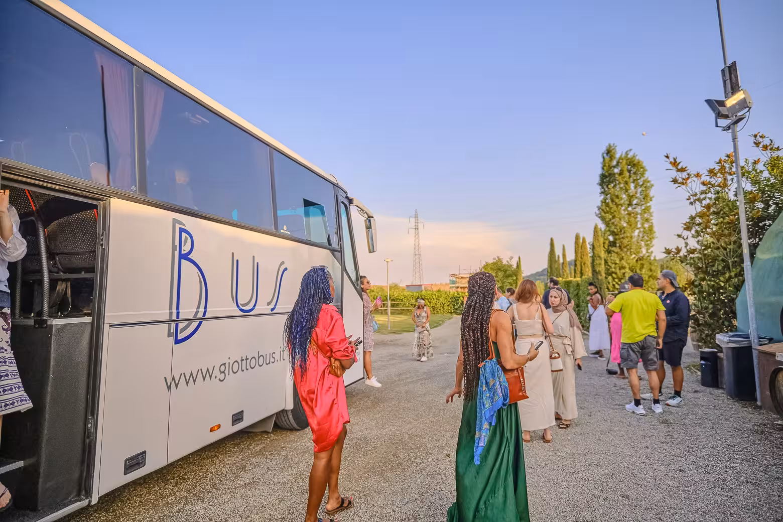 Tourists arriving by bus for a Chianti winery tour, ready to explore vineyards and enjoy a curated wine tasting.