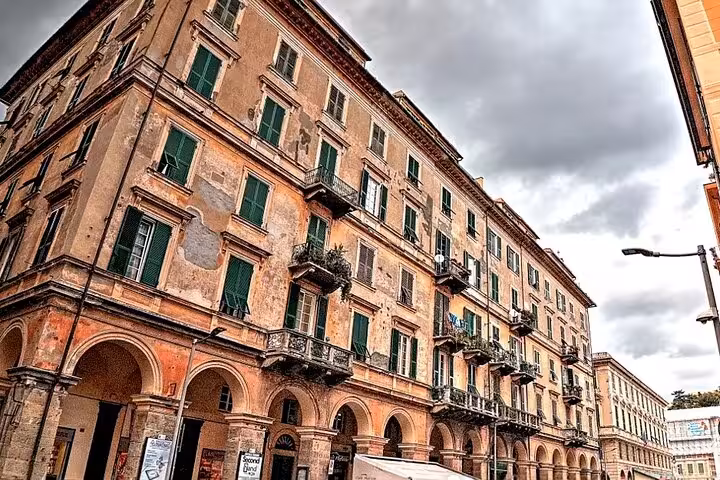 Historic architecture of Chiavari's old town, showcasing charming rustic buildings with green shutters.