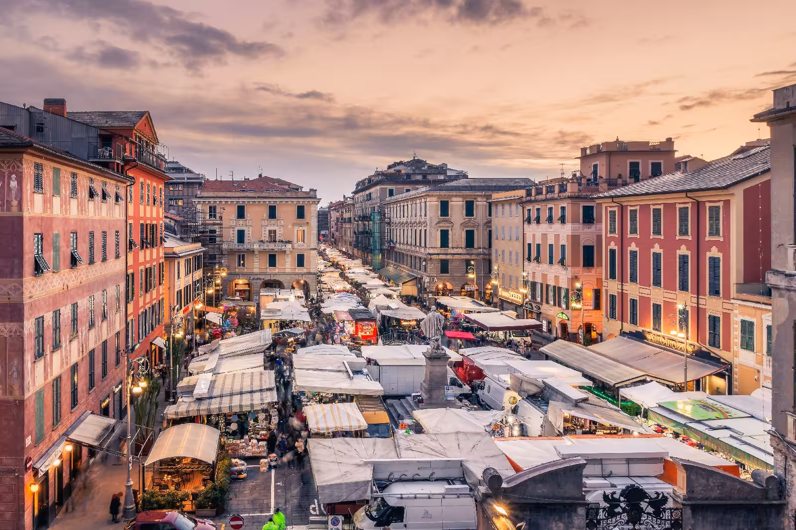Bustling Chiavari market at sunset featuring vibrant stalls and historic architecture for an immersive food tour.