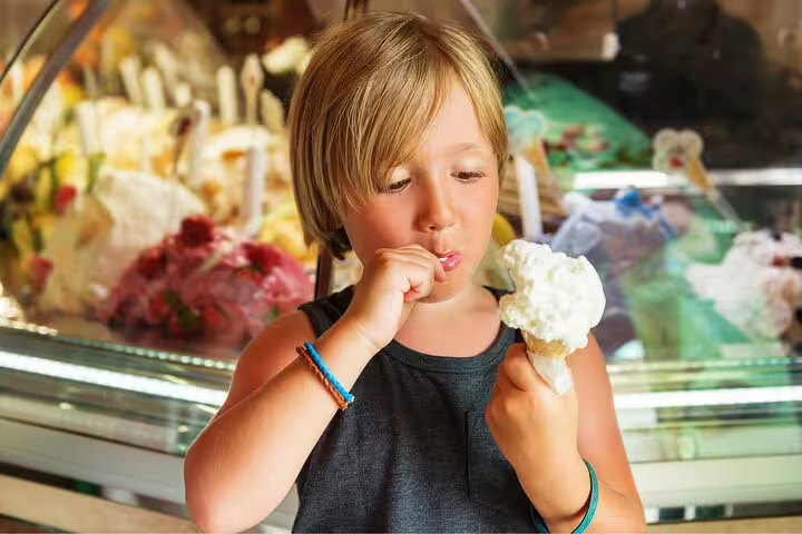 Child enjoying gelato during Highlights of Milano Private Walking Tour near Duomo and Castle, showcasing authentic Italian flavors.