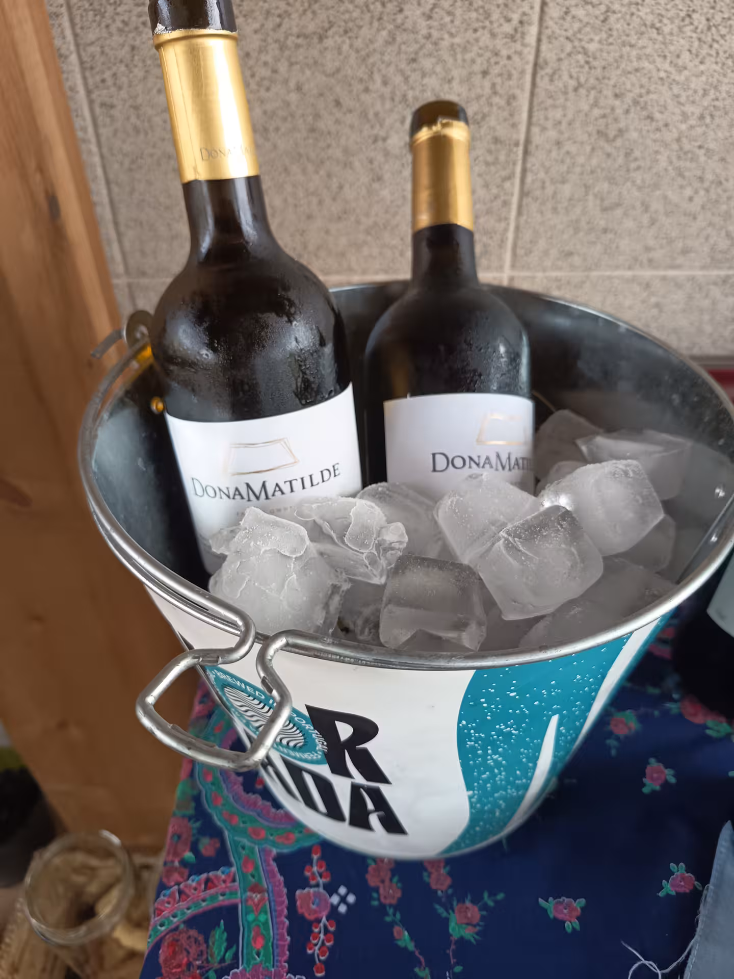 Chilled wine bottles in an ice bucket, ready for a Porto culinary experience, enhancing the Francesinha making tour.