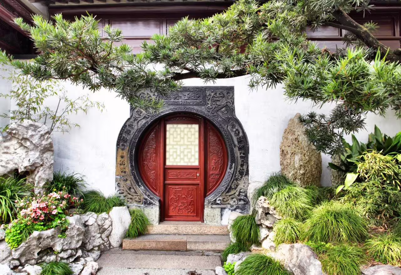 Discover intricate circular doorways and lush greenery on a private China Explorer tour.