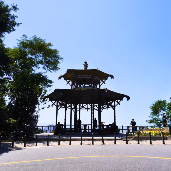 The Chinese Pagoda in Tijuca Forest offers panoramic views, silhouetted against a clear blue sky.