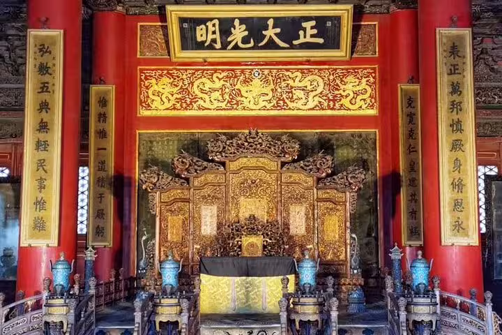 Intricately carved throne room in a historic Chinese palace, showcasing traditional architecture and design.