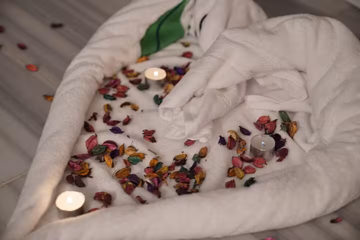 Rose petal bath with candles and plush towels at Sharm El Sheikh chocolate magic spa experience