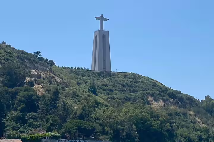 Marvel at the iconic Christ the King statue overlooking Lisbon's lush landscapes on a private full-day tour.