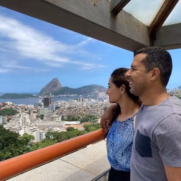 Couple enjoying panoramic view of Rio de Janeiro from Christ the Redeemer on private tour.