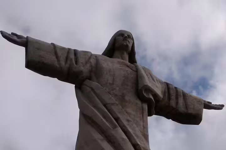 Majestic Christ Redeemer statue under a dramatic sky, highlighting Funchal Old Town's cultural and historical charm.