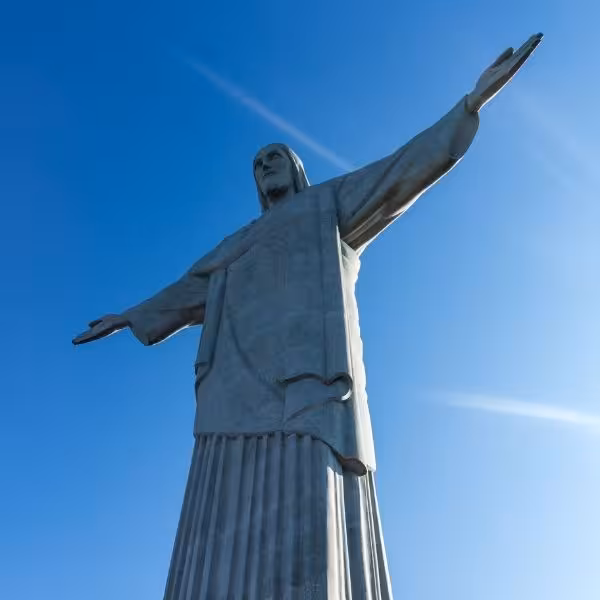 Christ the Redeemer statue with arms wide open against a clear blue sky, featured on the private tour.